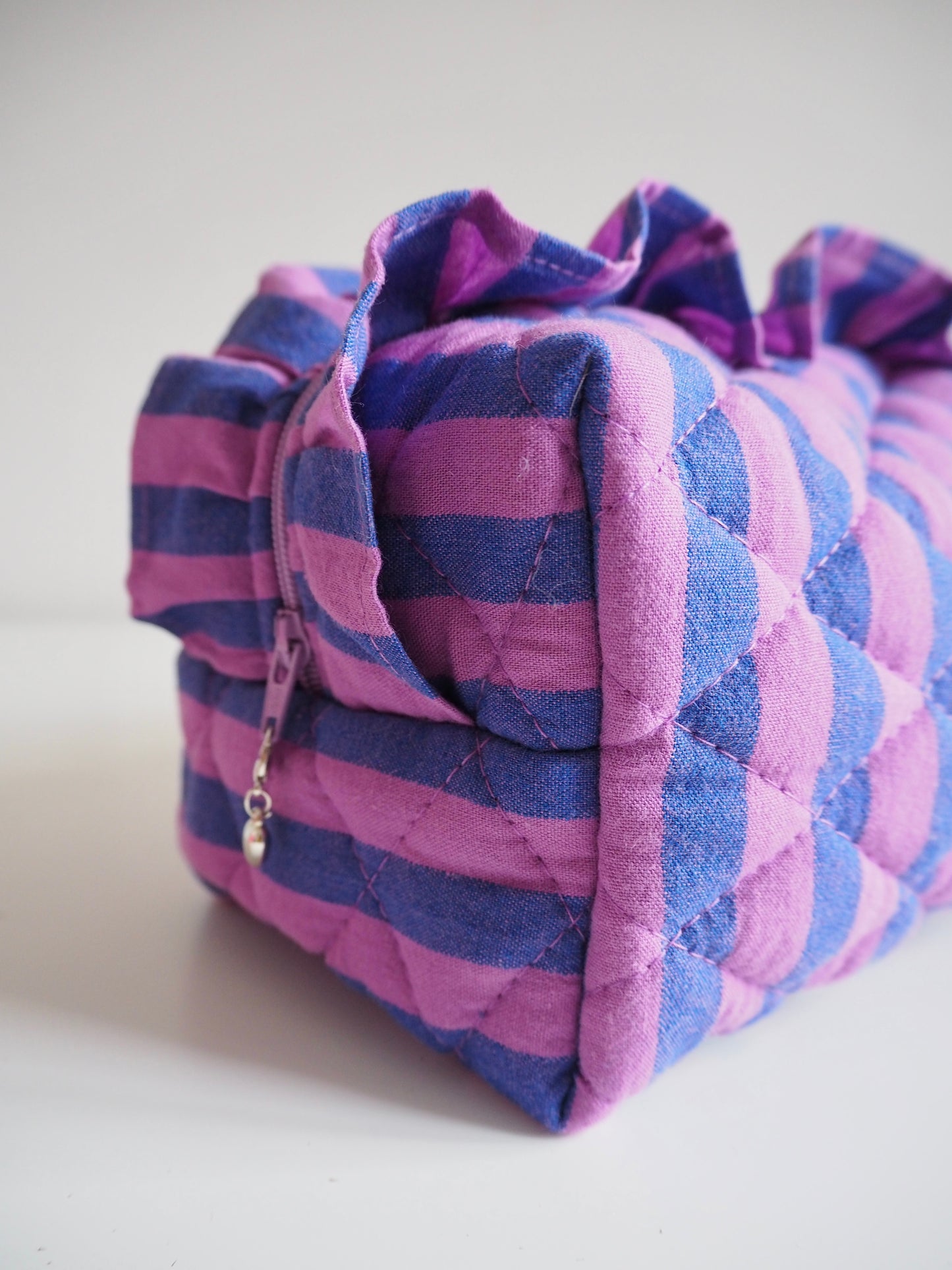PURPLE STRIPE FRILL QUILTED MAKEUP BAG