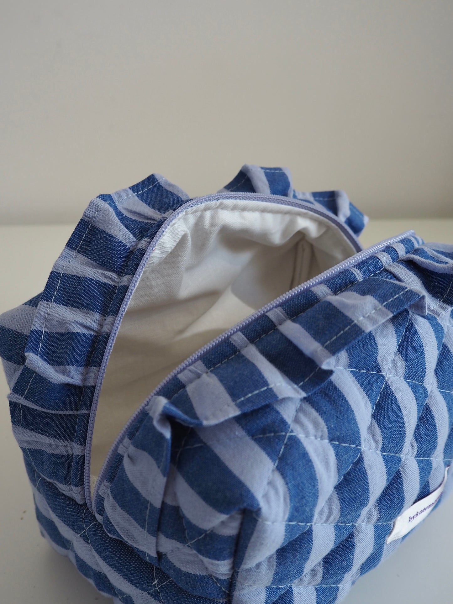 BLUE STRIPE FRILL QUILTED MAKEUP BAG